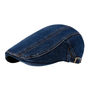 Classic dark blue denim newsboy cap with orange stitching and metal side buckle