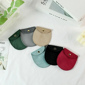 Variety of velvet jewelry pouches with snap buttons in multiple colors for accessories