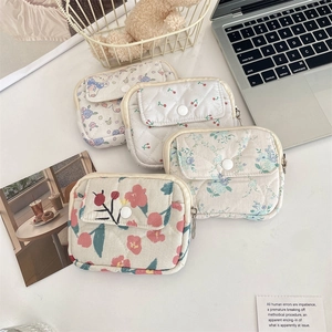 Detailed set of four floral quilted organizer pouches with metal hooks and snap buttons