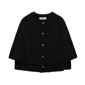Close-up of black knit poncho with round neck and buttons on a white background