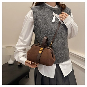 Retro dark brown frosted shell bag with gold hardware shown in a vintage outfit context