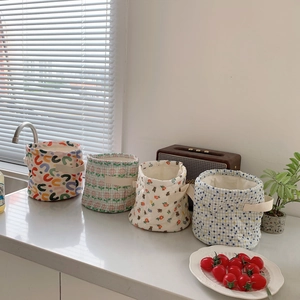 Detailed set of four quilted fabric storage baskets with handles in mixed floral patterns