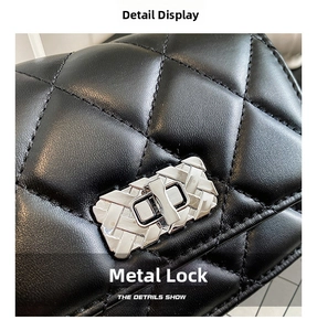 Macro view of a classic black quilted leather texture and a silver rectangular turn-lock