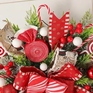 Christmas candy wreath with red stripes bow, berries and snowman ribbon decoration