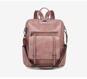 Detail of dusty pink PU leather backpack showing main double zippers and woven shoulder strap
