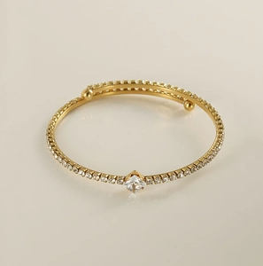 Close-up of 18K gold-plated bangle featuring pavé-set zircons and a central square diamond