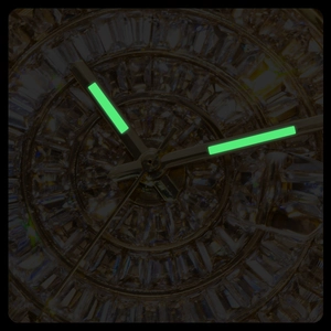 Macro shot showing luminous green watch hands on a luxury dial with baguette cut crystals