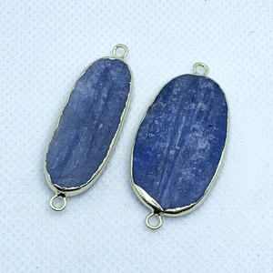 Detail of natural blue kyanite connectors with gold plated edges and double loops