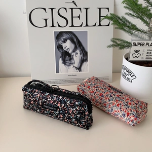 Detail of floral corduroy pencil cases in black and beige with smooth zippers