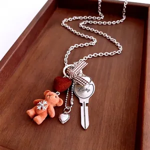Flocked bear necklace with heart and lucky key charm on silver chain for women