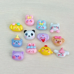 Flat lay of colorful resin cartoon animal heads for DIY crafts and phone case decor