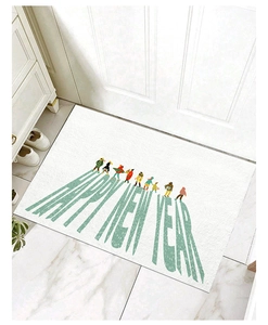Detail of white Happy New Year entrance mat with green lettering on marble floor