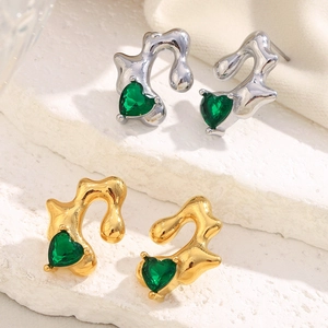 Detailed shot of irregular liquid metal heart earrings in gold and silver finish