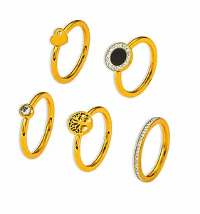 Macro display of gold rings featuring tree of life and heart designs with zircon stones