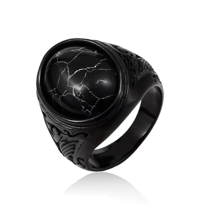 Detail of vintage wolf steel ring showing black stone inlay and intricate side carvings