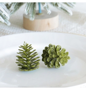Close-up of two realistic green pine cones as festive Christmas decorations on a white plate