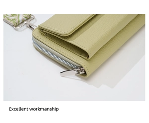 Detail of light green litchi texture leather cross-body bag with silver zipper hardware