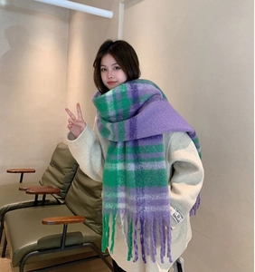 Detailed view of green and purple plaid mohair scarf texture and soft tassel fringe