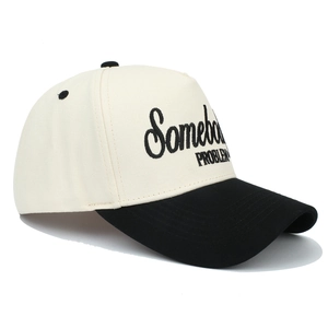 Two-tone trucker cap in cream and black with Somebody Problem embroidery