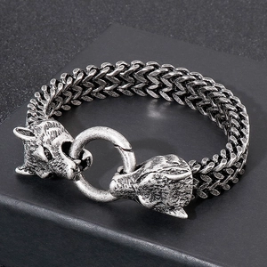 Detail of vintage oxidized steel wolf head bracelet with double-woven chain and ring clasp