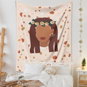 Close-up of bohemian wall tapestry featuring abstract female portrait with floral crown