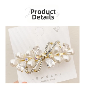 Close-up of pearl and butterfly crystal spring hair clip with gold metal base details