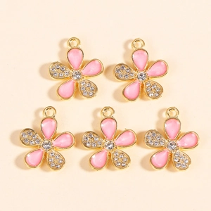 Detailed view of pink enamel flower charms with crystals for DIY jewelry making