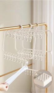 Macro detail of multi-clip drying rack showing non-slip teeth for secure sock hanging