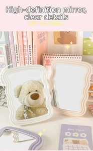 Macro shot of wavy frame desktop mirror with high-definition reflection and pastel finish