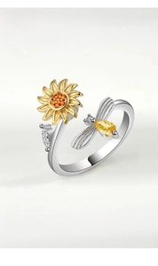 Detailed view of an adjustable sunflower and honey bee ring with vibrant gemstones