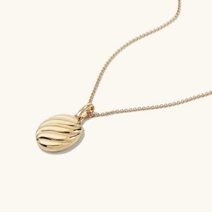 Gold stainless steel oval ripple pendant necklace with textured geometric design
