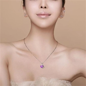 Elegant S925 sterling silver necklace with heart-shaped purple stone on a model neck