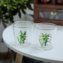 Detail of elegant glass dessert cups featuring 3D lily of the valley flower inner design