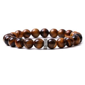 Macro detail of natural tiger eye stone beads with a textured silver metal accent bead