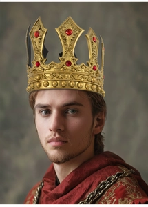 Detail of vintage gold king crown with red gemstones and ornate embossed patterns