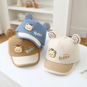 Detailed shot of baby bear baseball caps in blue, brown and beige colors with cute 3D ears