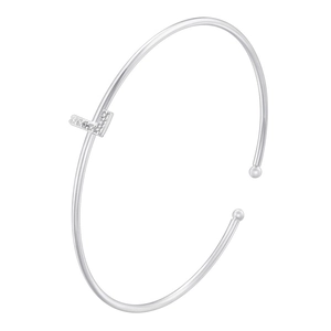 Macro detail of silver-colored bangle featuring a sparkling zircon-set letter L pendant