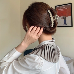 Large gold metal hair claw clip with cat eye stones for elegant women's updo hairstyles