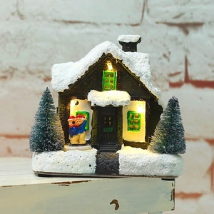 Luminous Christmas miniature village house with LED lights and snow-covered trees decor