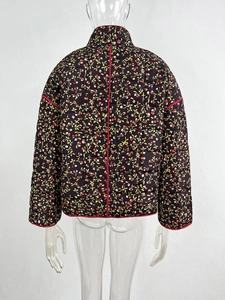 Detailed back view of a black quilted cotton jacket with red cherry floral pattern