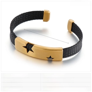 Detail of black woven texture stainless steel cuff featuring gold star cutouts