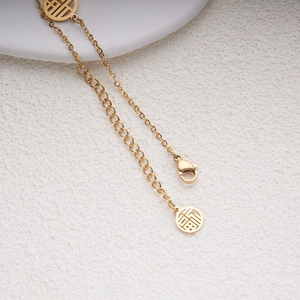 Bracelet vintage en acier inoxydable doré avec deux pendentifs ronds caractère Fu