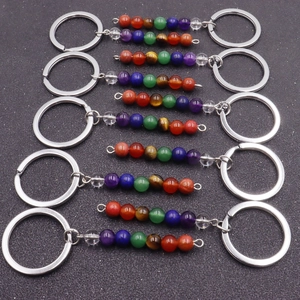 Macro shot of colorful natural crystal beads and metal rings on multiple keychains