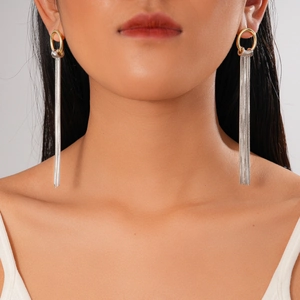 18K gold plated round dangling tassel chain earrings shown on a model's ear
