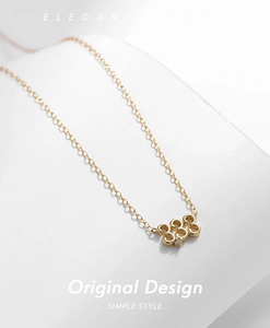 Close-up of gold 925 sterling silver necklace featuring number 333 pendant with diamond