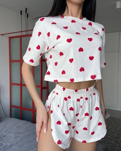 Detail of white two-piece lounge set with red heart print and drawstring shorts
