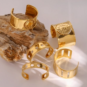 Bohemian gold open bangles with hollow patterns and sun relief on natural stone