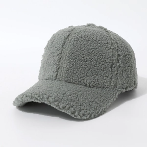 Close-up detail of dark grey sherpa baseball cap showing its fuzzy texture and curved brim