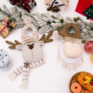 Detailed view of Christmas reindeer and gnome plush door hangers with festive decorations