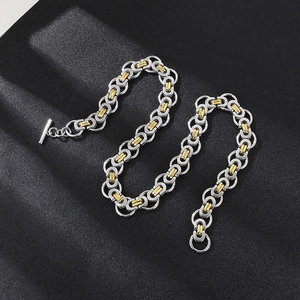 Detailed view of two-tone Byzantine chain necklace with T-bar toggle clasp in stainless steel